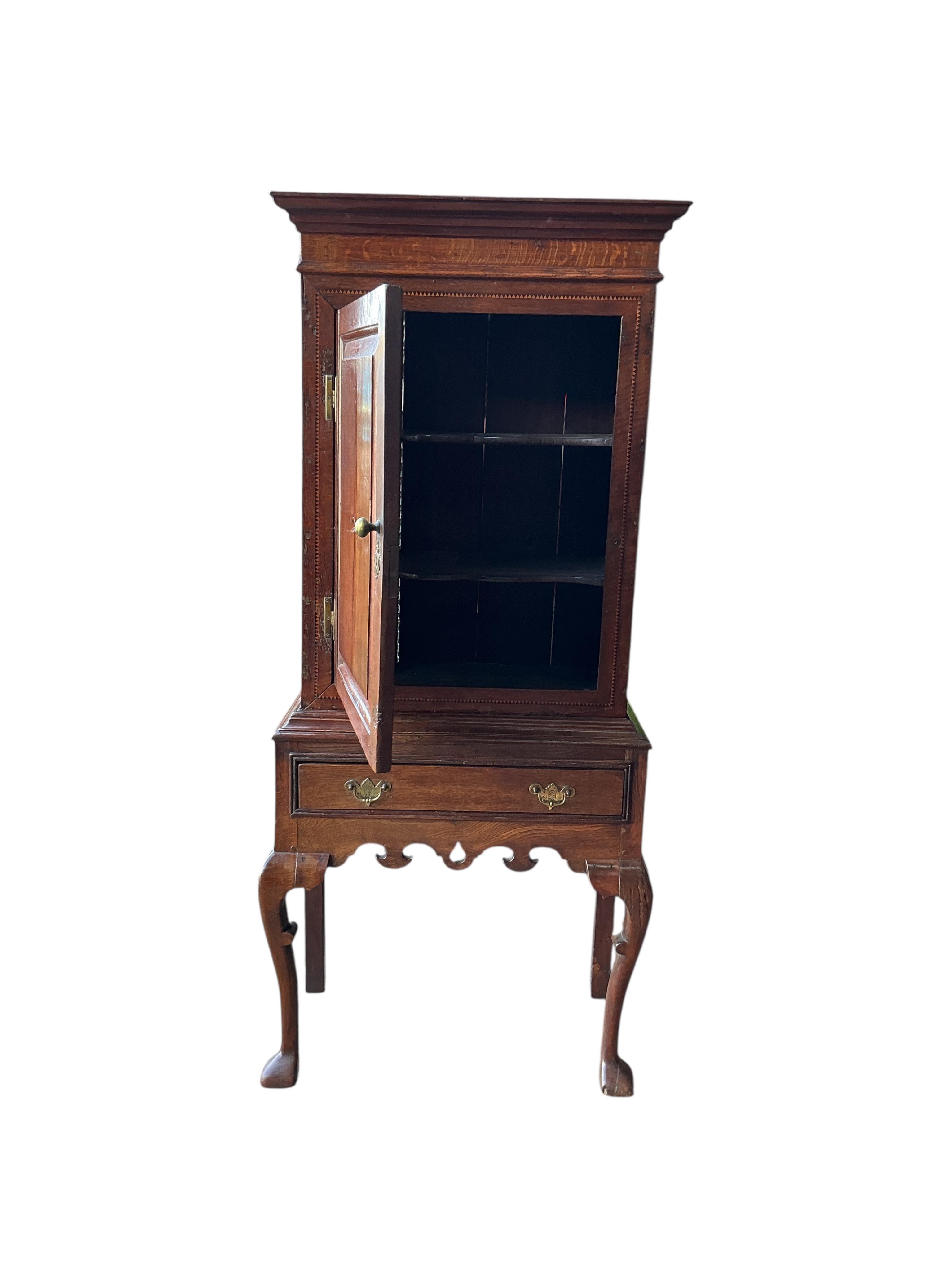 An 18th century and later inlaid oak cabinet on stand, width 72cm, depth 36cm, height 162cm